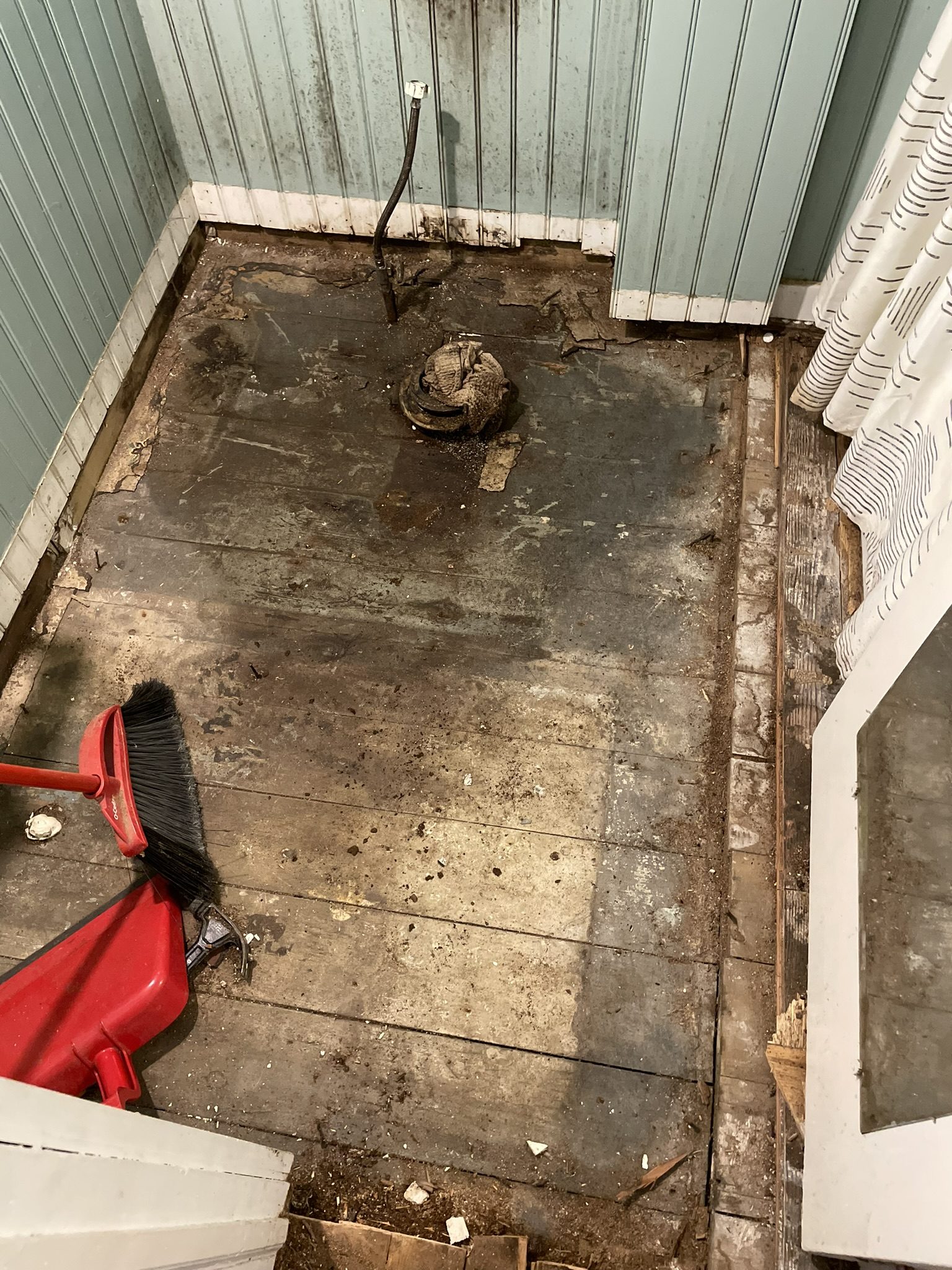 Before: old deck boards removed showing rotted structure underneath