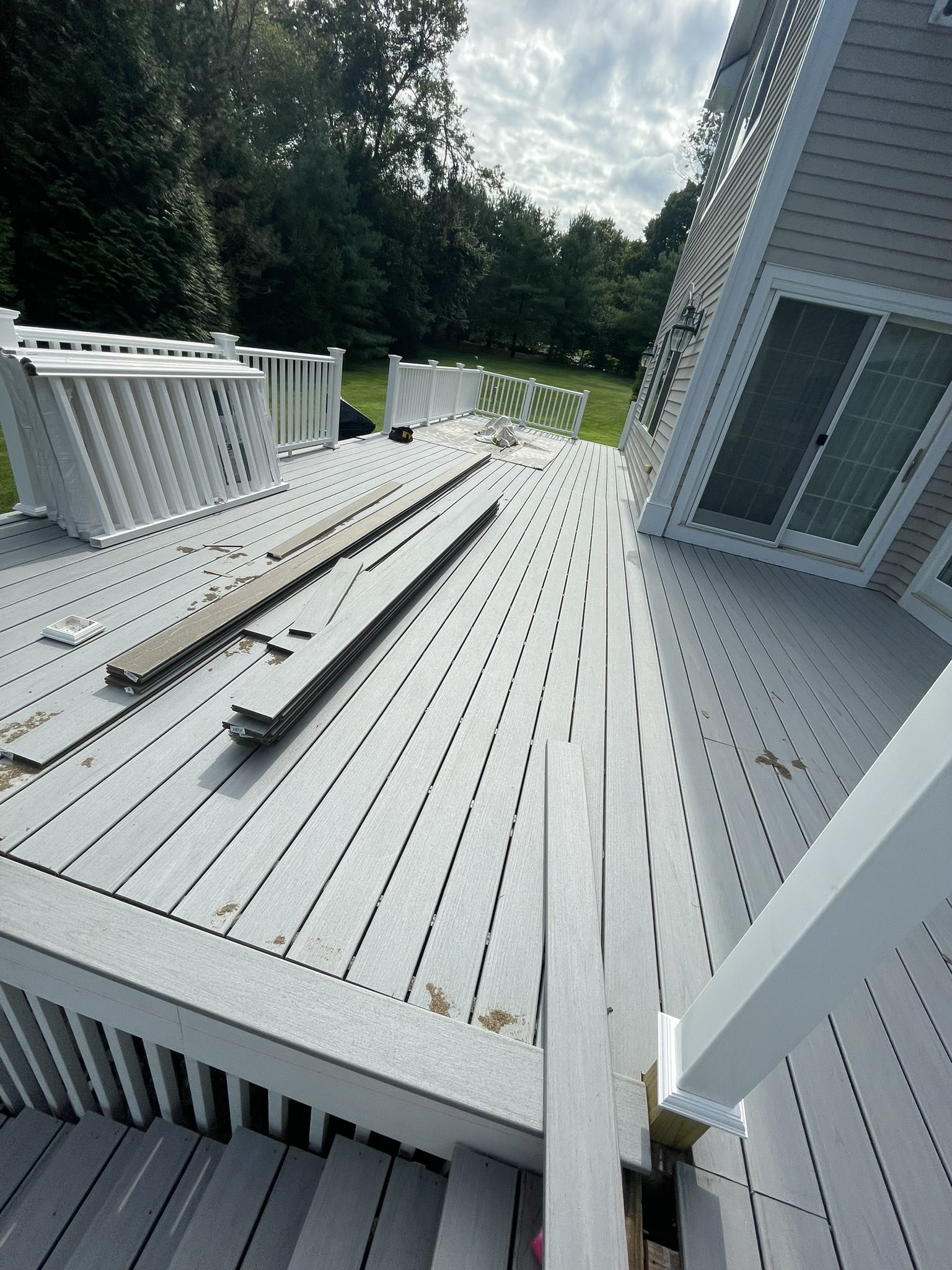 During: composite deck boards being installed over new frame