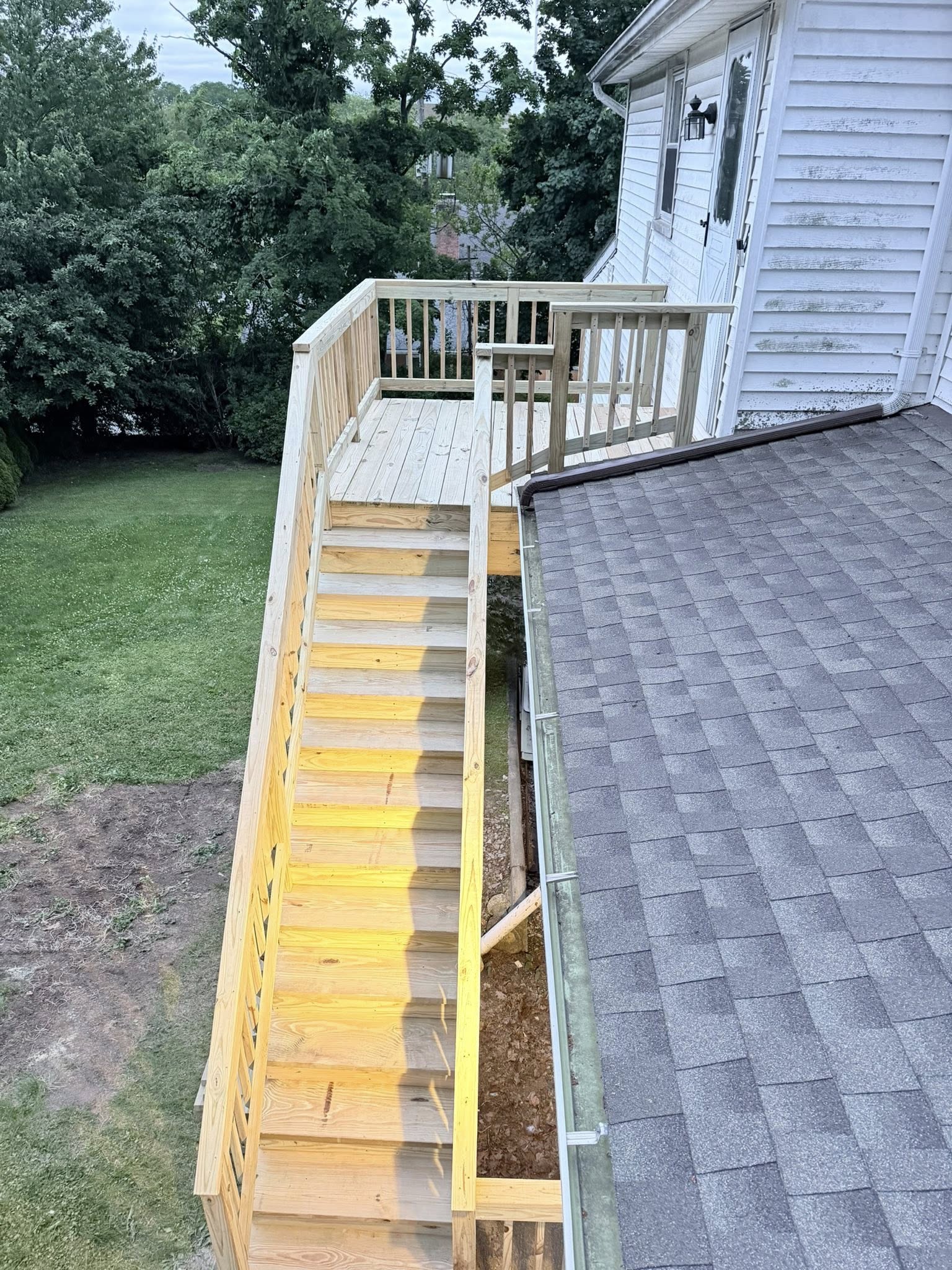 New pressure treated staircase side view with railing — Westchester County