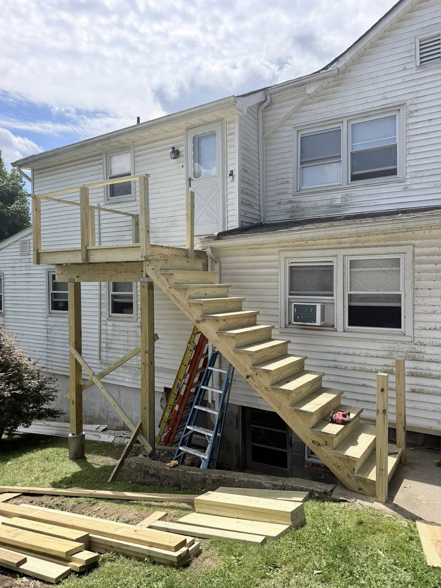 Deck framing construction in progress — new posts and structural supports