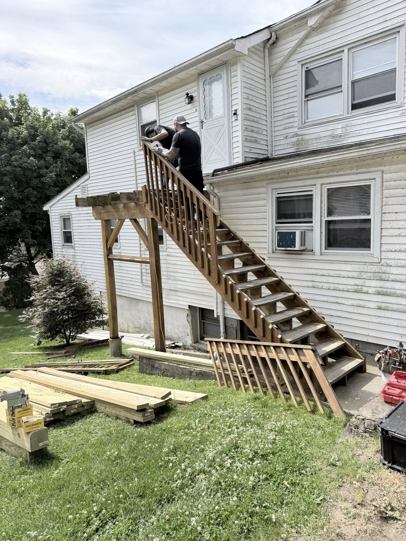 Staircase construction — new stringers and treads being installed