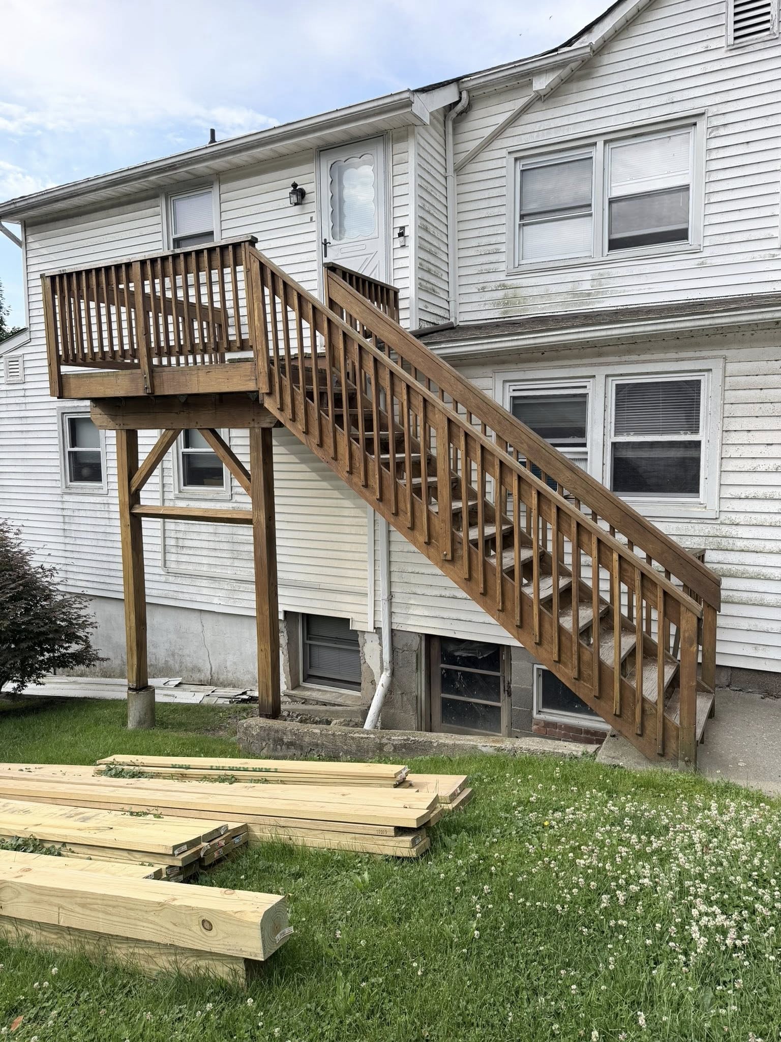 Before: old second floor deck with worn railing and aged lumber