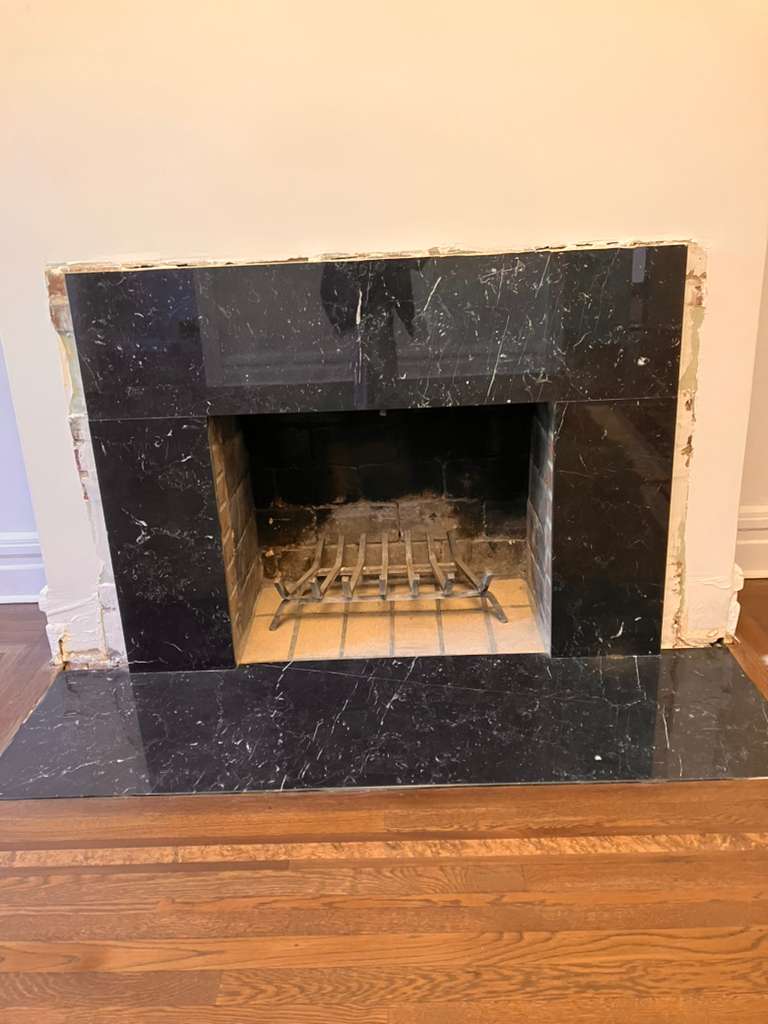Before: bare black Nero marble fireplace surround with no mantel — Westchester NY