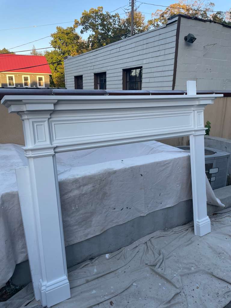 Finished mantel staged outside, curing before transport to site — custom fireplace mantel, Westchester NY